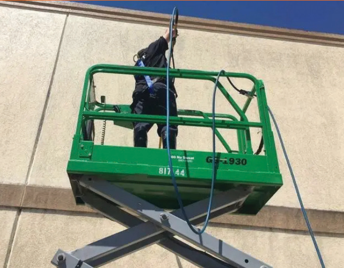Aerial commercial building cleaning using a scissor lift